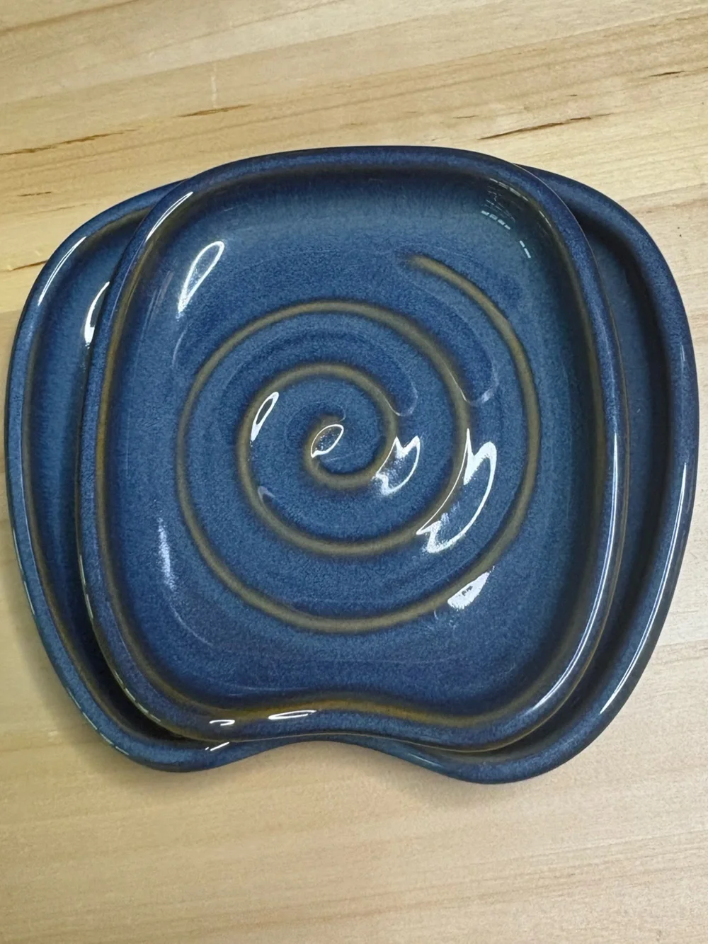 Pampered Chef Nesting Spoon Rest Set featuring a blue glaze with a swirl design.
